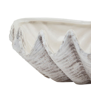 Close detail of the ceramic shell bowl's wavy edge and textured exterior finish.