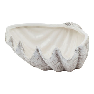 White ceramic decorative bowl shaped like a clam shell, showing the ribbed exterior texture and glossy interior cavity.