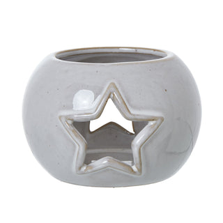 Round white ceramic tealight holder with a central star-shaped aperture. Front view on white background.