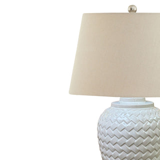 Close up of the cream linen shade and the glossy white basket weave ceramic base.