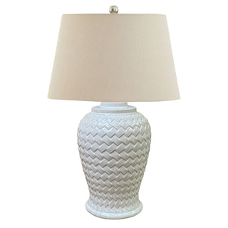 White ceramic table lamp featuring a textured basket weave base and a conical cream linen shade.