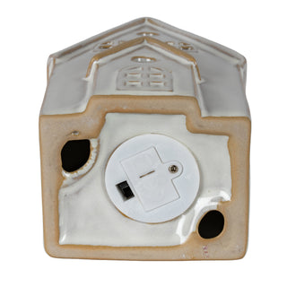 Detail of the base of the ceramic house, showing the white plastic LED light unit and battery access.