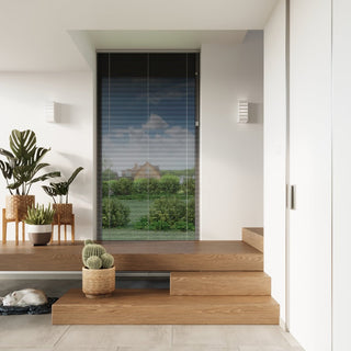 Modern hallway scene showing two unlit ceramic wall lamps flanking a window overlooking a garden view.