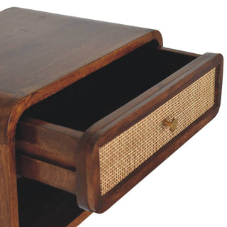 Angled close-up of the chestnut bedside unit with the woven drawer fully open, showing the interior.
