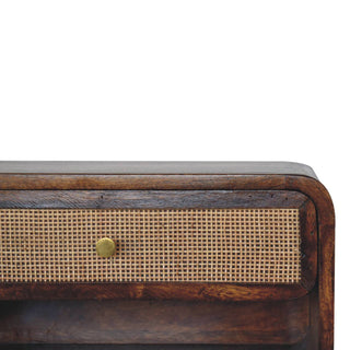 Detail shot showing the woven cane drawer texture, brass knob, and rounded chestnut wood top edge.