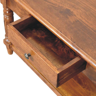 Detail shot of the coffee table with a drawer open, showing the metal knob and interior wood finish.