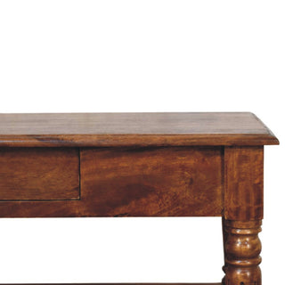 Close-up showing the rich chestnut wood finish, drawer front, and the carved detail of the turned leg.