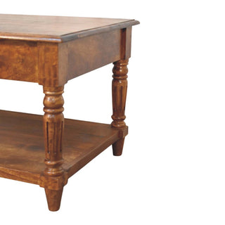Detail shot of the chestnut coffee table structure, showing the turned legs supporting the top and lower shelf.