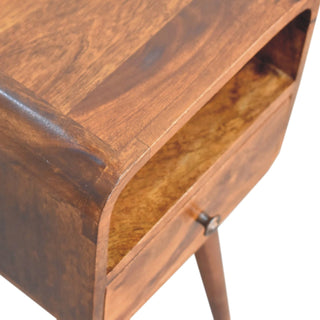 Detail shot showing the rich chestnut wood grain, the open storage shelf, and the small decorative metal drawer knob.