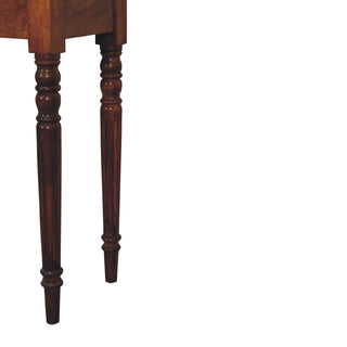 Detail shot of the lower half of the chestnut desk legs, highlighting the turned shape and vertical fluting.