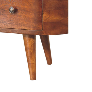 Tight close-up showing the junction of the rounded base, tapered wooden legs, and drawer knob.