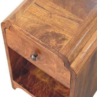 Close-up showing the curved edges, scalloped drawer front, and open storage shelf.