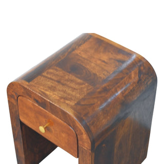 Detail shot showing the variegated wood grain pattern on the nightstand's curved top panel.