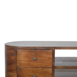 Close-up of the unit's dark top surface, rounded corner, and the division between the top drawers and the open media shelf.