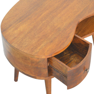 Detail shot of the coffee table's curved top surface and the drawer pulled open, revealing the wood grain.