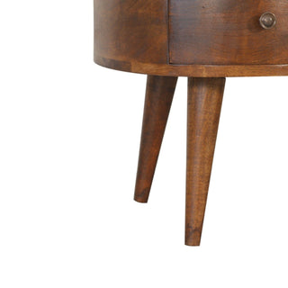 Close detail of the coffee table's curved base and two angled, tapered wooden legs.
