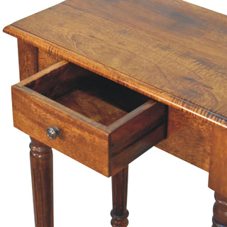 Detail shot of the chestnut desk surface and the single drawer open, showing the drawer box and metal knob.