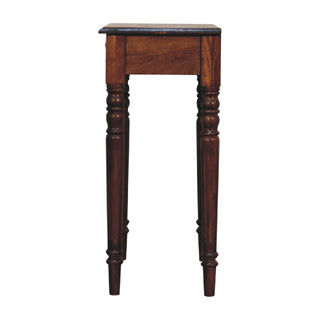 Side profile view of the chestnut writing desk, showing the depth of the desktop, the side panel, and the two turned legs.