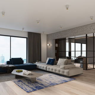 Contemporary living room with multiple concrete ceiling lamps installed on the white ceiling.