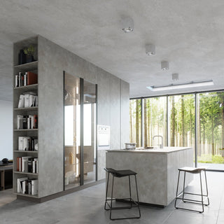 Four concrete ceiling lights installed sequentially above a matching concrete kitchen island.