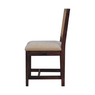 Full side profile of the dark wood chair showing the cream boucle seat and rattan back