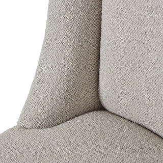 Detail of the seam where the cream twill upholstered seat meets the curved backrest.