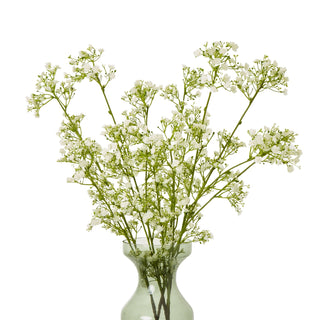 Artificial cream gypsophila spray stems arranged in a light green glass vase.