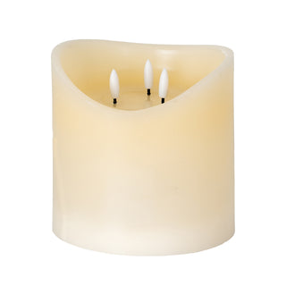 Cream coloured LED candle with a melted top and three internal LED wicks. Plain studio shot.