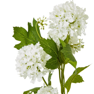 Close detail of the artificial cream viburnum flower clusters and lobed green leaves.