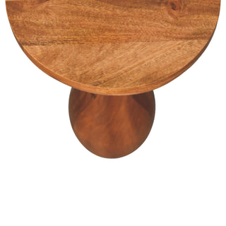 Overhead view showing the circular tabletop meeting the curved, bulbous wooden base.