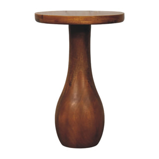 Dark wood side table with a round top and a vase-shaped, curved base.