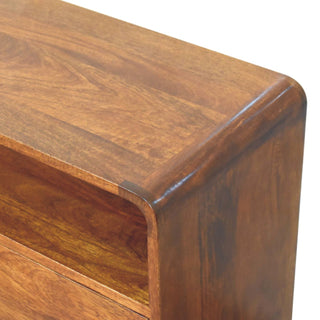 Detail shot showing the console table's seamless curved top edge and the natural wood grain texture.