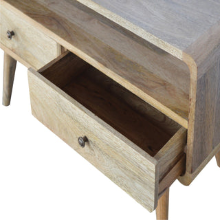 Detail of the light wood media unit showing the bottom drawer fully open and the open central storage compartment.