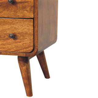 Detail of the lower drawer, rounded side panel, and two angled, tapered wooden legs.