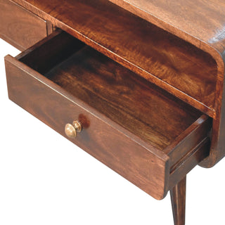 Close-up of the curved walnut media unit showing one drawer pulled open, revealing the interior and the storage shelf above.