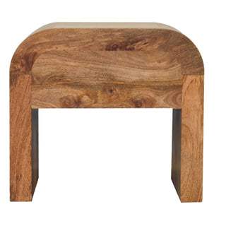 Front-on view of the wooden bedside table structure, highlighting the thick curved top and open base.