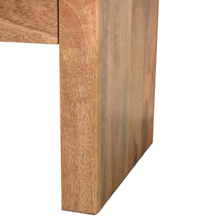 Close-up of the bedside table's thick vertical side panel, highlighting the varied grain pattern and colour.