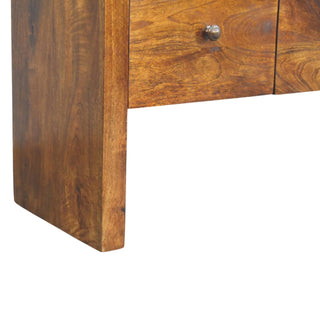 Close-up showing the thick side support panel and the base structure of the chestnut chest, featuring prominent wood grain.