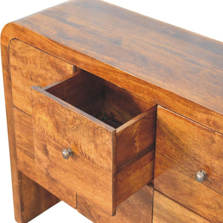 Close-up of the chestnut chest showing an upper drawer pulled open, revealing the internal wooden box construction.