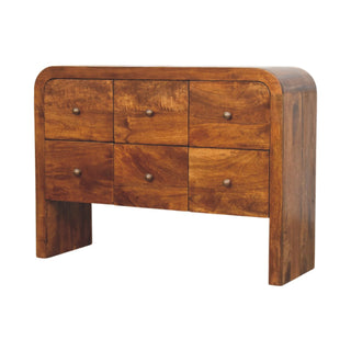 Three-quarter view of the chestnut drawer chest, showing the rounded side profile and the U-shaped base.