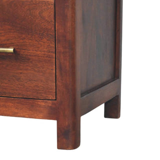 Lower section of the bedside table showing the smooth, rounded legs and recessed side panel.