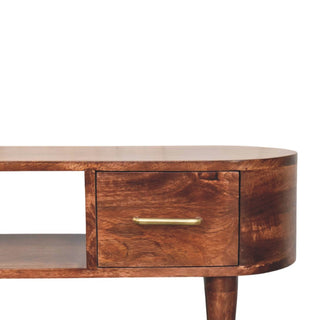 Detail of the media unit showing the dark wood texture, curved edge, drawer, and brass bar handle.