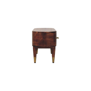 Side view of the media unit showing its depth, curved profile, and tapered legs with brass tips.
