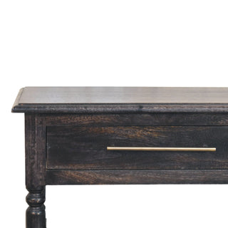Close-up of the dark wood drawer front, brass bar pull, and turned leg detail on the side table.