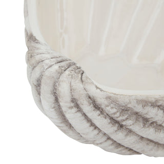 View highlighting the rough, greyish, ribbed ceramic exterior meeting the smooth, pale white interior.