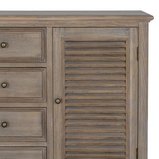 Corner detail of the dresser base, showing the contrast between the slatted door and the adjacent drawer fronts.