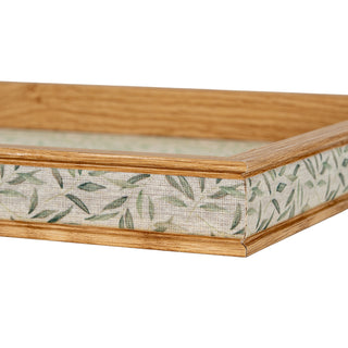 Close-up of the tray corner, showing the textured leaf pattern fabric inset between the moulded oak wood frame.