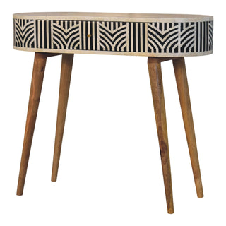 Oval console table with black and white geometric bone inlay and four angled, tapered wooden legs.