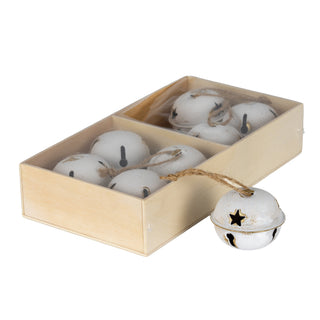 Eight distressed white metal bells packaged in a light wooden box. One bell, featuring a star cutout, rests beside the box.