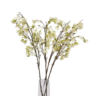 Bunch of artificial white and green flowering stems in a clear glass vase, isolated on white.